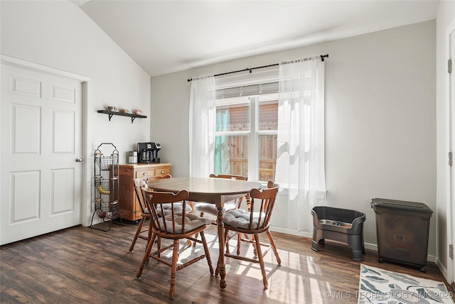 dining area featuring vaulted ceiling, baseboards, and dark wood-type flooring