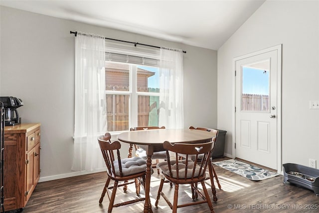 dining area with baseboards, lofted ceiling, and dark wood-style floors