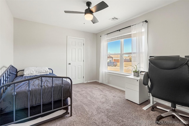 bedroom featuring ceiling fan, light colored carpet, visible vents, and baseboards