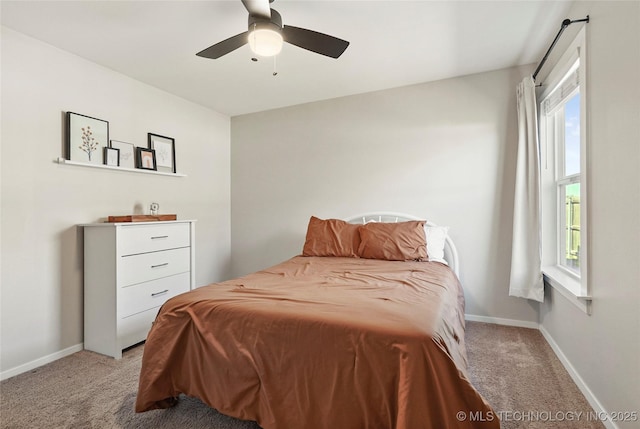 bedroom featuring light carpet, ceiling fan, and baseboards