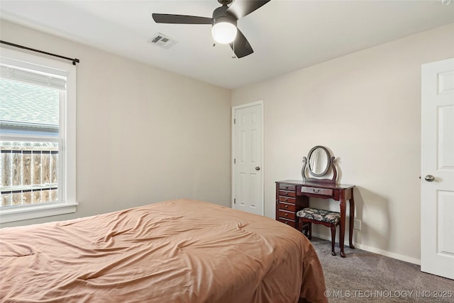 bedroom with visible vents, carpet floors, baseboards, and ceiling fan