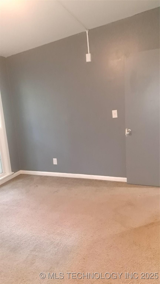 empty room with carpet floors and baseboards