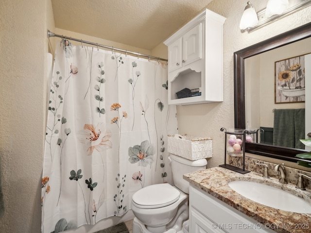 full bathroom featuring curtained shower, a textured wall, toilet, a textured ceiling, and vanity