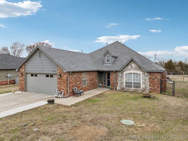 view of front of home featuring a garage, a shingled roof, fence, driveway, and a front yard