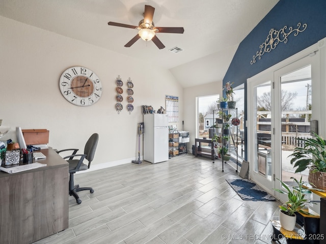 home office featuring baseboards, visible vents, a ceiling fan, wood tiled floor, and vaulted ceiling