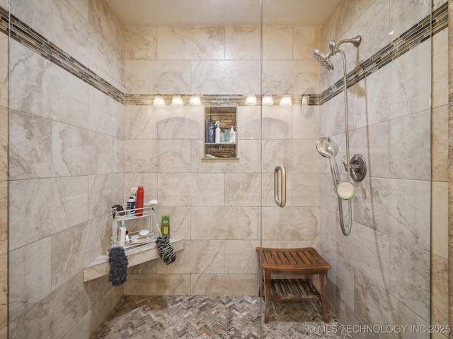 full bath with a tile shower