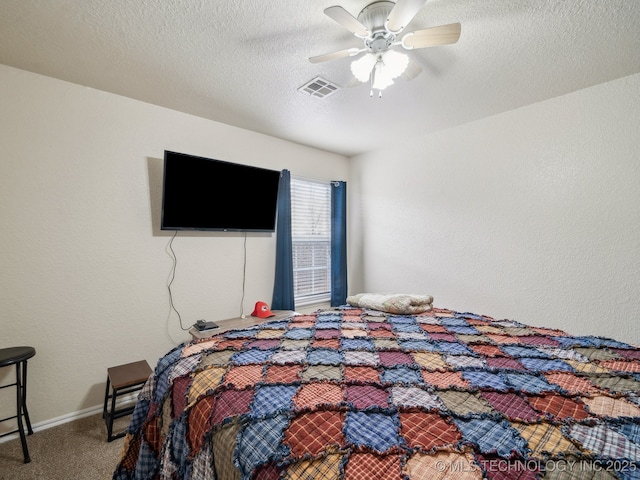 carpeted bedroom featuring visible vents, a textured wall, a ceiling fan, a textured ceiling, and baseboards