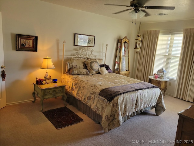 carpeted bedroom with ceiling fan, visible vents, and baseboards