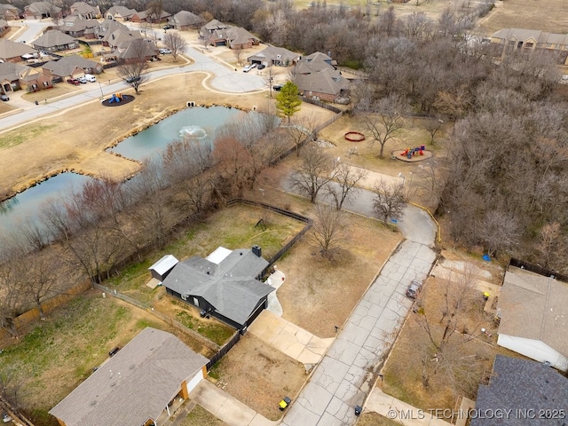 bird's eye view featuring a water view and a residential view