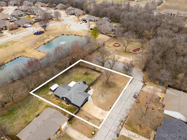 drone / aerial view featuring a water view and a residential view