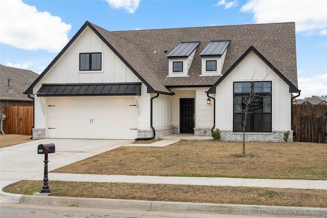 modern farmhouse featuring concrete driveway, roof with shingles, fence, and a standing seam roof