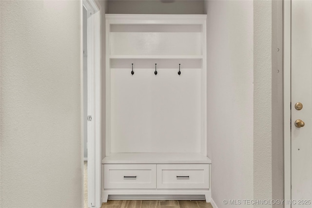 mudroom featuring light wood-style floors and baseboards