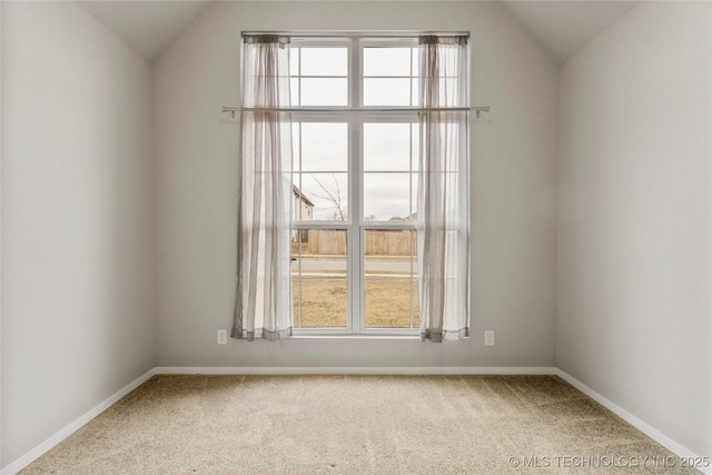 spare room with lofted ceiling, plenty of natural light, and carpet flooring