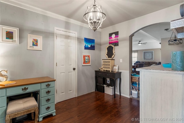 interior space featuring arched walkways, dark wood-type flooring, and ceiling fan with notable chandelier