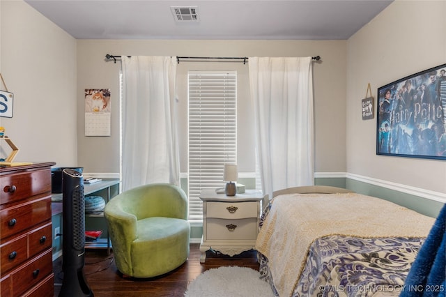 bedroom with wood finished floors and visible vents