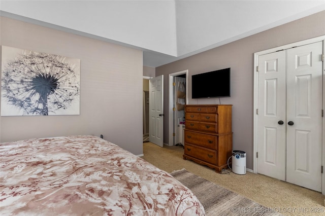 bedroom featuring a closet and light colored carpet