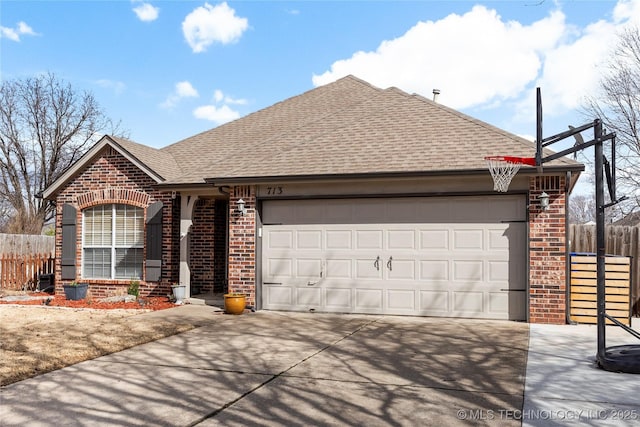 ranch-style home with roof with shingles, fence, concrete driveway, and brick siding