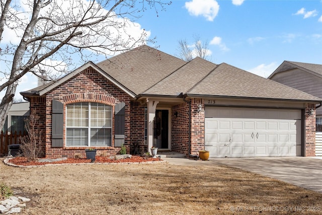 view of front of house with a garage, roof with shingles, concrete driveway, and brick siding