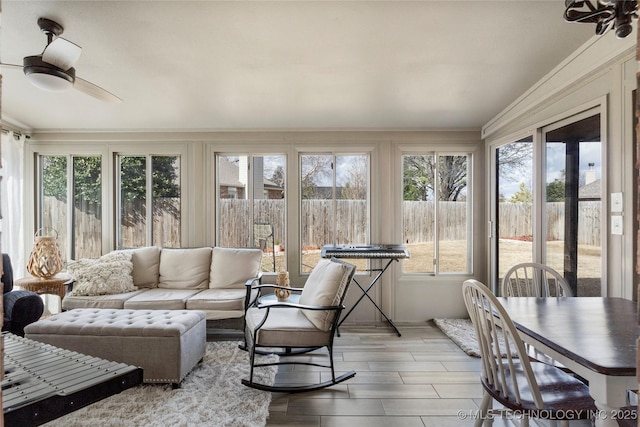 sunroom / solarium with a ceiling fan