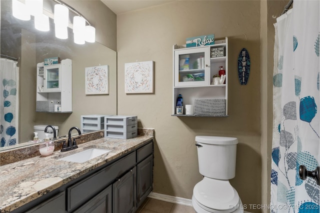 bathroom featuring curtained shower, toilet, vanity, tile patterned flooring, and baseboards