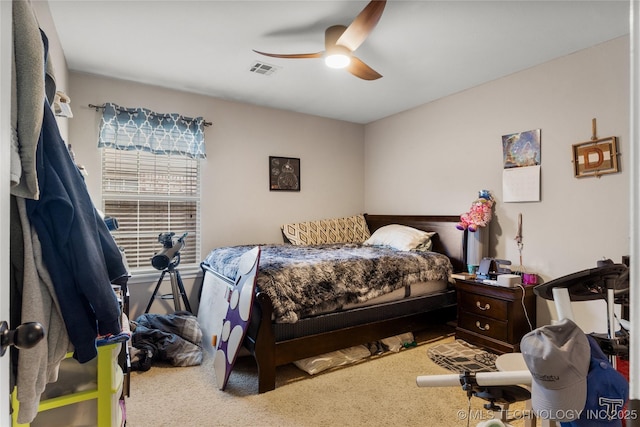 bedroom featuring carpet floors, visible vents, and ceiling fan