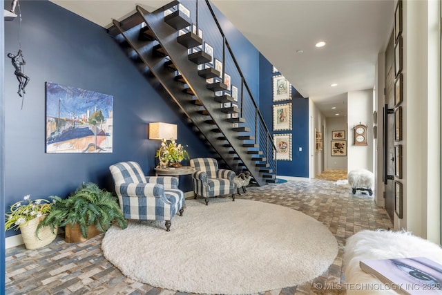 living area with stairs and recessed lighting