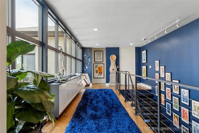 interior space featuring recessed lighting, wood finished floors, and track lighting