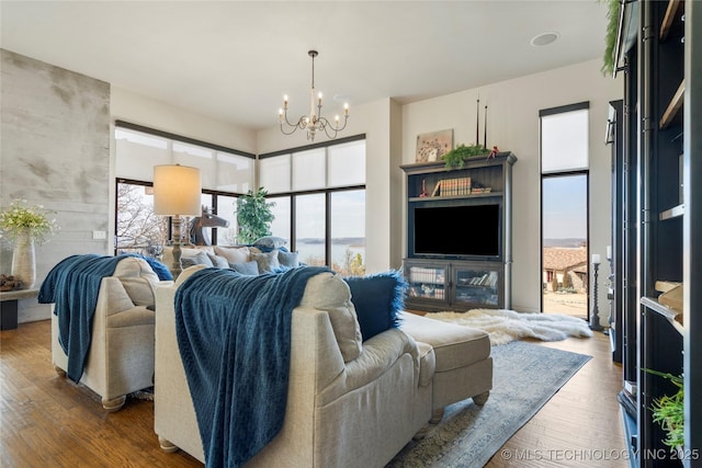 living area with a notable chandelier and wood finished floors