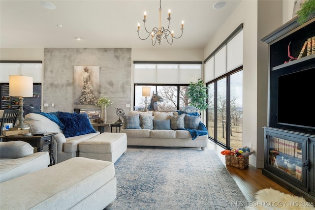 living area with wood finished floors and a notable chandelier