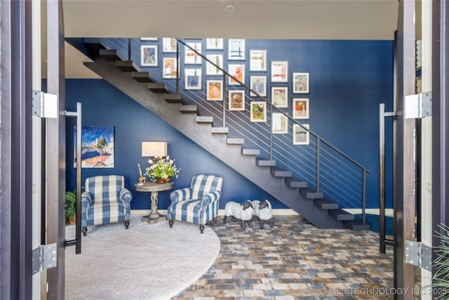 interior space featuring baseboards and stairs