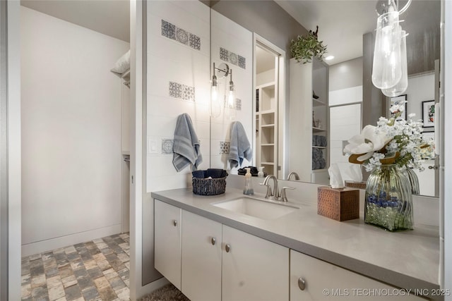 bathroom featuring baseboards and vanity