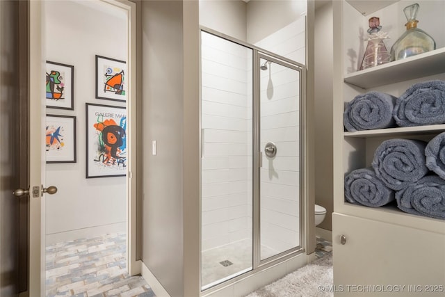 full bath with brick floor, baseboards, a shower stall, and toilet