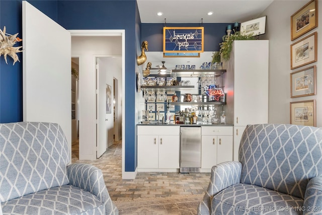 bar featuring a dry bar, stainless steel refrigerator, and recessed lighting