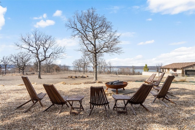 view of yard featuring a water view and a fire pit