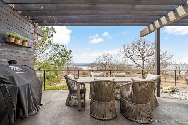 view of patio featuring a grill, outdoor dining area, and a pergola