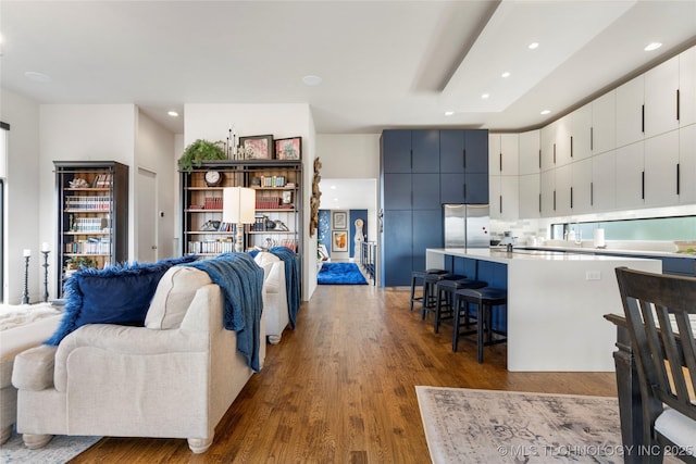 living area featuring dark wood-style floors and recessed lighting