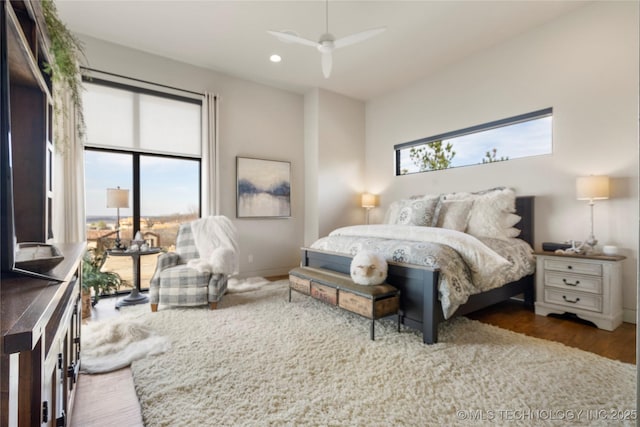 bedroom featuring recessed lighting, multiple windows, baseboards, and wood finished floors