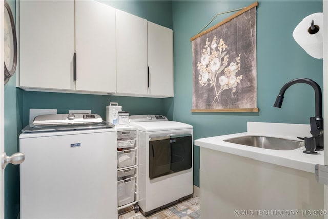 laundry room featuring cabinet space, a sink, and washer and clothes dryer