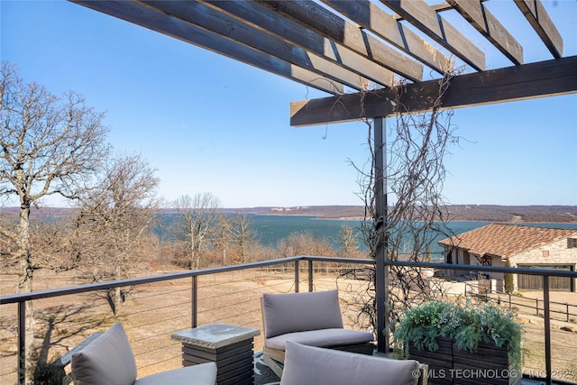 balcony featuring a water view and a pergola