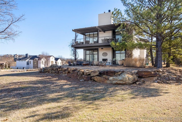 back of house featuring a chimney and a pergola