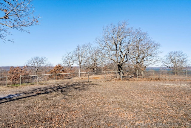 view of yard with a rural view and fence