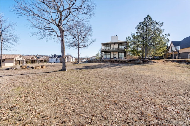 view of yard featuring a balcony