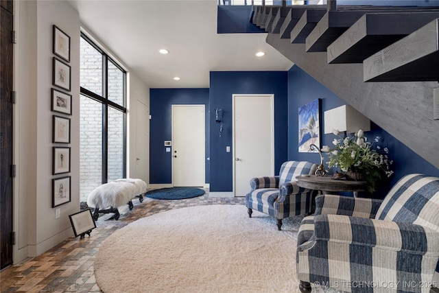 sitting room with baseboards, brick floor, and recessed lighting