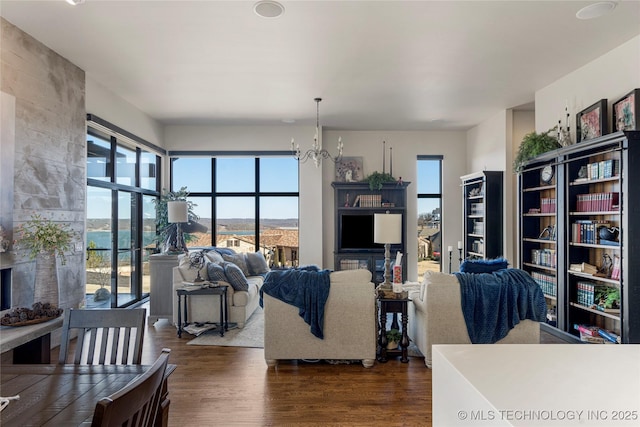 living room featuring wood finished floors and an inviting chandelier