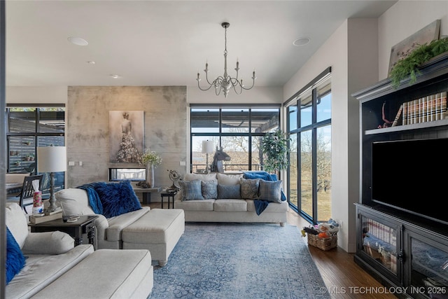 living room with a notable chandelier and wood finished floors