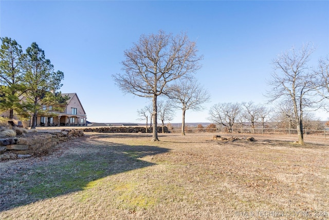 view of yard with a rural view and fence