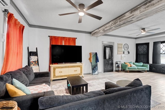 living room with ceiling fan, ornamental molding, and wood finished floors