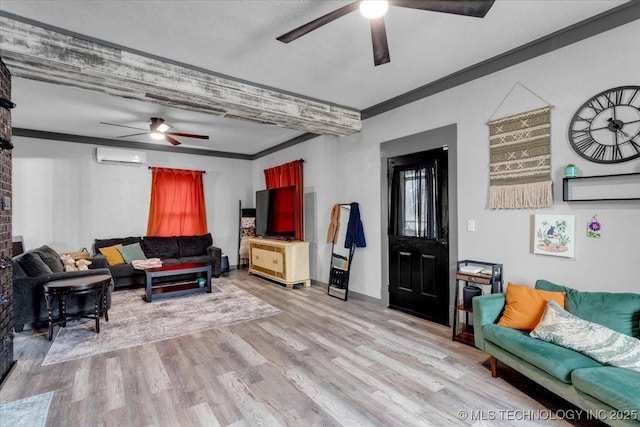 living room featuring an AC wall unit, ornamental molding, wood finished floors, and a ceiling fan