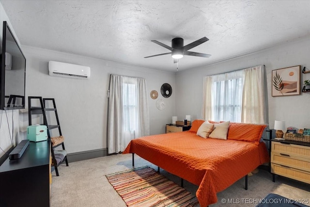 bedroom with a ceiling fan, carpet, a wall unit AC, and a textured ceiling