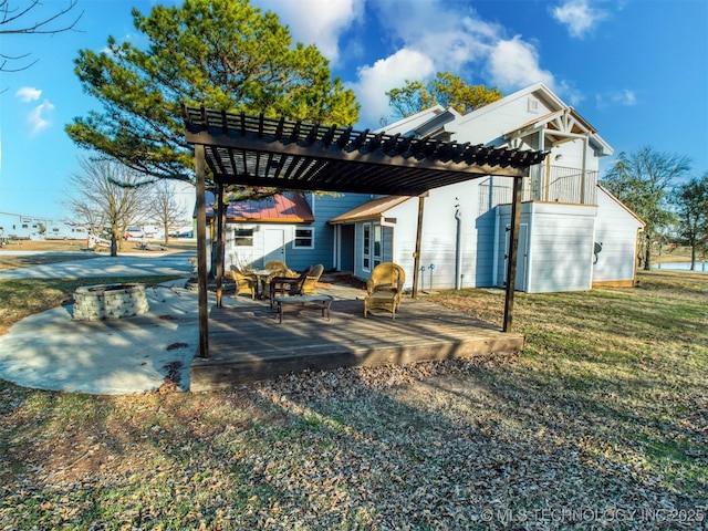 rear view of house with a yard, a pergola, and a patio